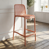 High-quality vertical-striped plastic bar stool; stackable and suitable for various settings such as outdoors and beaches; available in a range of customizable colors.